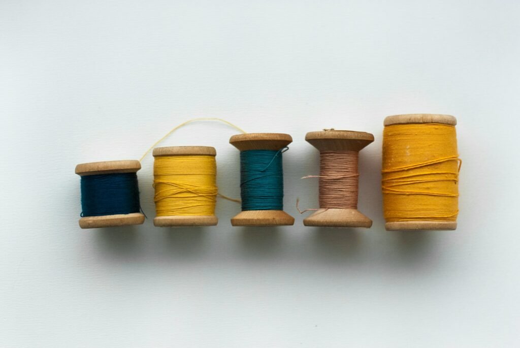 a row of spools of thread sitting next to each other