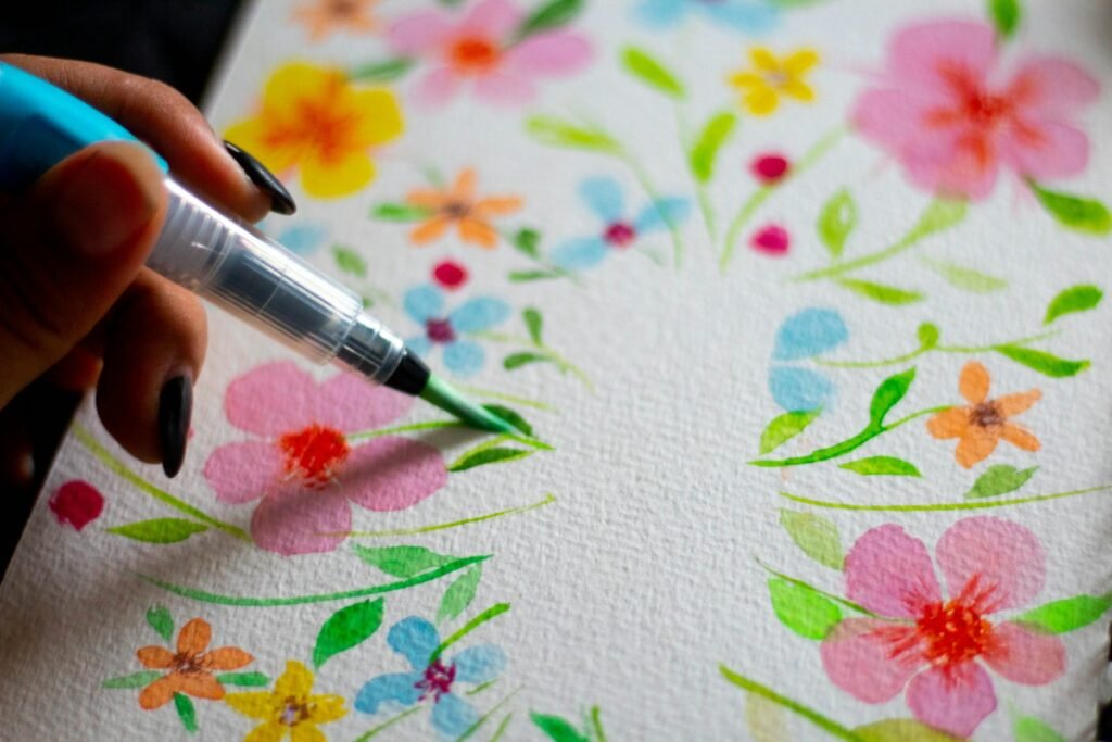 a person writing on a piece of paper with a marker